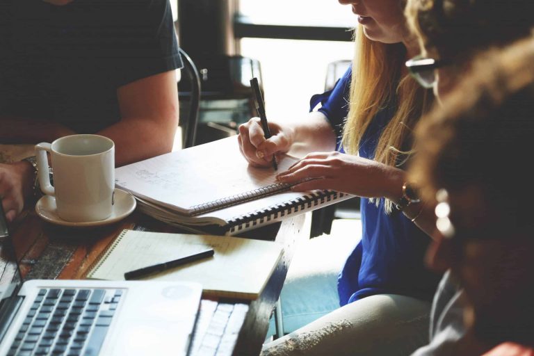 affiliate manager discussing program with others at a table